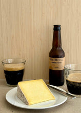 Load image into Gallery viewer, Bottle of 'The Kernel' beer with a glass of dark beer and a piece of cheese on a plate.