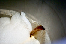 Load image into Gallery viewer, Close up of brown beer being transfered to a tank