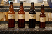 Load image into Gallery viewer, Four bottles of The Kernel Brewery beer on a metal surface.
