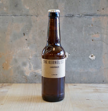 Load image into Gallery viewer, Brown beer bottle with &#39;The Kernel&#39; label on a wooden surface and concrete wall background
