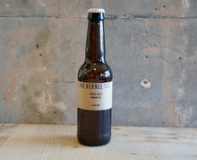 Load image into Gallery viewer, Beer bottle labeled &#39;The Kernel&#39; on a textured surface with a gray background
